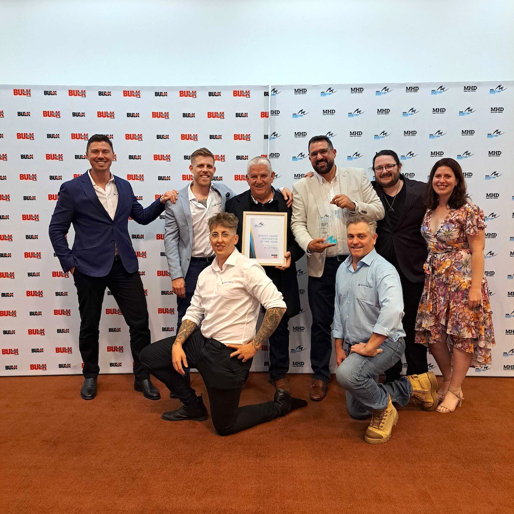 Allotrac Team standing with Supply Chain Innovator of the Year Award